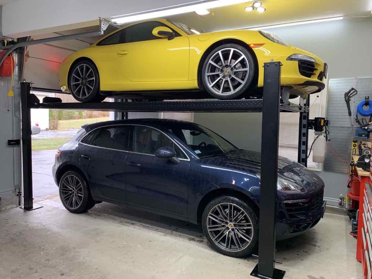 TEC 8000S storage lift with a yellow Porsche 911 above a Macan in a Grafton, MA home garage